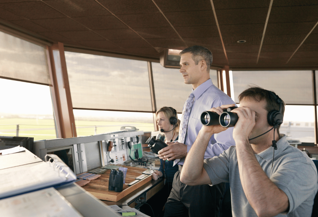 An air traffic control team using a crash alarm system to ensure that they can respond quickly to an incident.