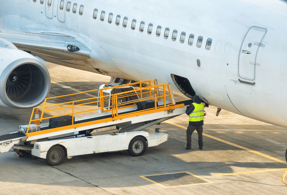 Ground crew starting to unload an airplane at an airport.